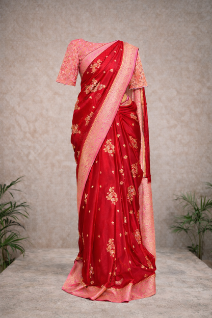 Red and pink traditional silk saree with gold zari motifs and contrast border